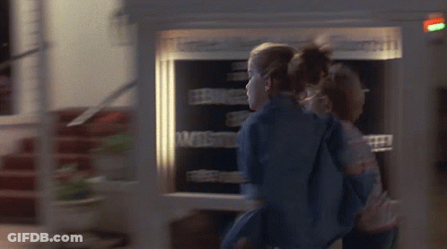 Couple Standing In Front Of Welcome Sign GIF