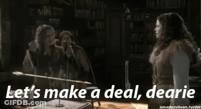 Couple Standing Next To Each Other Saying Let's Make A Deal Dearie GIF