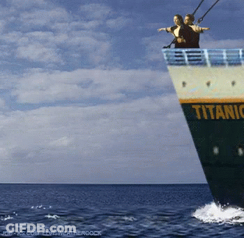 Couple Standing On Titanic Boat In Ocean GIF