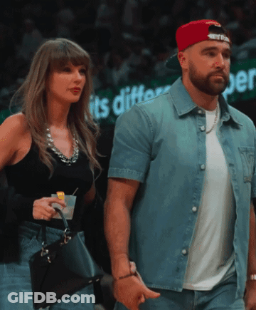 Couple Walking Past Sign Saying Its Different GIF
