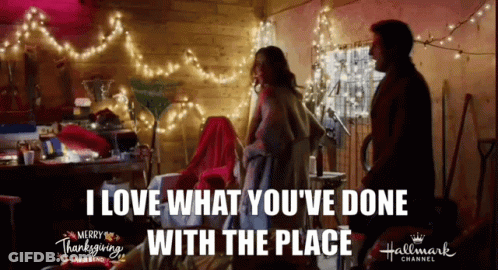 Couple With Christmas Lights Merry Thanksgiving Sign GIF