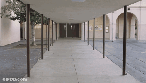 Covered Walkway Leading To Building With Sign Saying A GIF