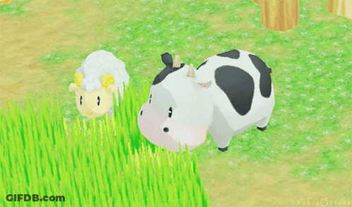 Cow With Black Spots And Sheep Standing In Grass GIF