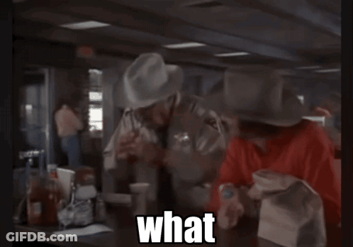 Cowboy Hat Man Calling Suit Man A Mental Case GIF