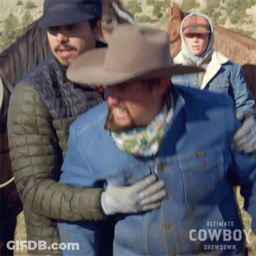 Cowboy Hat Man Held By Showdown Jacket Man GIF