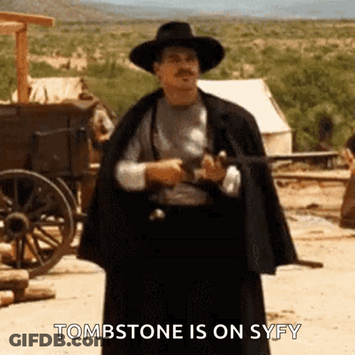 Cowboy Hat Man Holding Gun Saying Tombstone Is On Syfy GIF