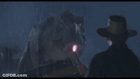 Cowboy Hat Man In Front Of Dinosaur With Flashlight GIF