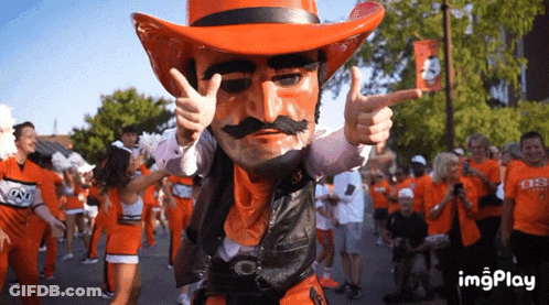 Cowboy Mascot Giving Thumbs Up In Front Of Crowd GIF