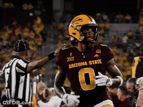 Cowboy Mascot Holding Gun In Front Of Allstate Banner GIF