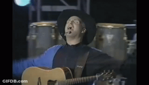 Cowboy Playing Acoustic Guitar Arms Outstretched GIF
