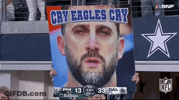 Cowboys Fan Holds Sign Saying Cry Eagles Cry GIF