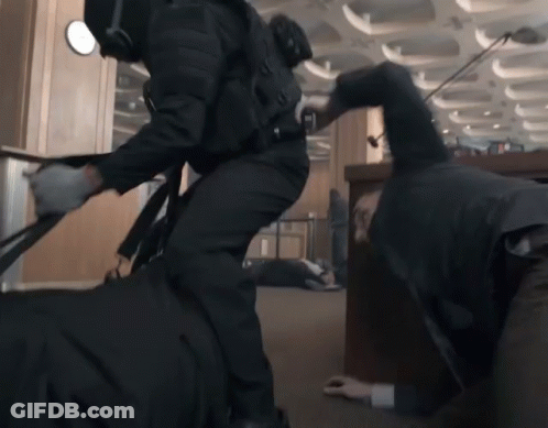 Crawling Man With Man In Black Suit GIF