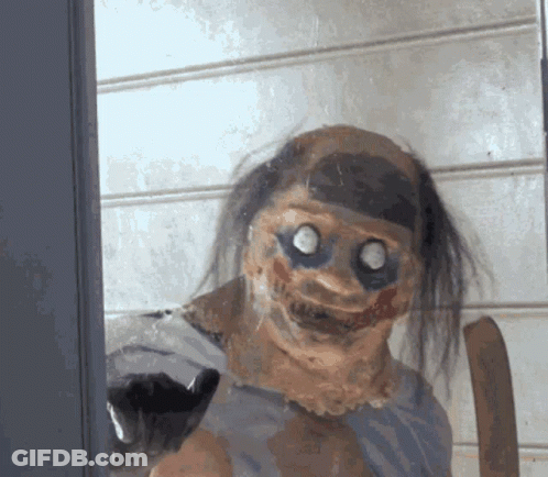Creepy Clown Behind Glass Door Looking At Camera GIF
