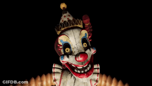 Creepy Clown With Crown Looking At Camera GIF