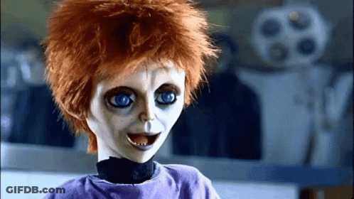 Creepy Doll With Red Hair And Blue Eyes In Purple Shirt GIF
