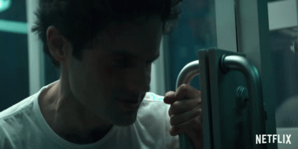 Creepy Laughing Joe Goldberg Holding Door GIF