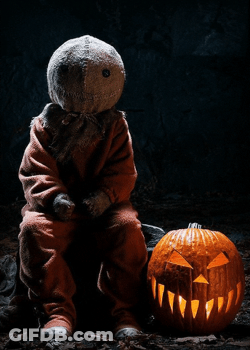 Creepy Sitting Creature With Pumpkin Lantern GIF