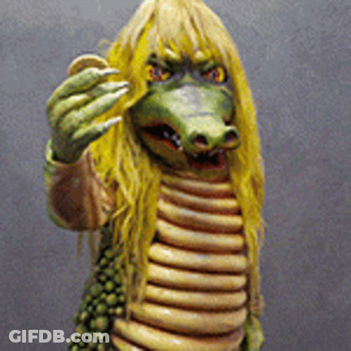 Crocodile Statue With Yellow Hair And Sharp Claws GIF