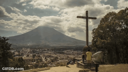 Cross With Mountain Surrounded By Trees GIF