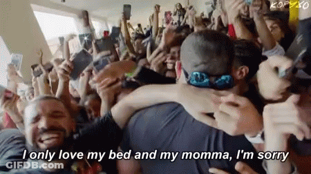 Crowd Around Man And Woman Hugging GIF