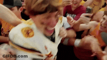 Crowd Around Man In White Shirt With Yellow Star GIF
