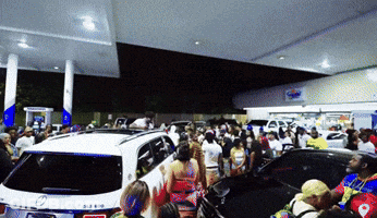 Crowd At Gas Station With White Mercedes GIF