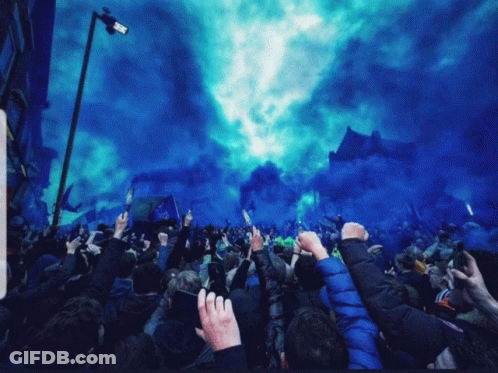 Crowd Fists Raised With Blue Smoke GIF
