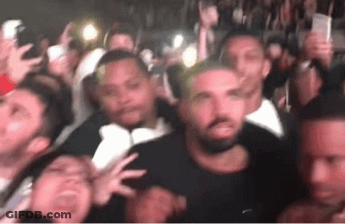 Crowd Gathered Around Man In Black Shirt GIF