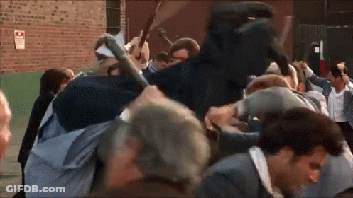 Crowd Gathered In Front Of Brick Building GIF