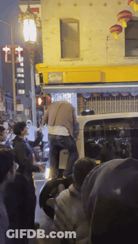 Crowd Gathered In Front Of Sprite Building GIF