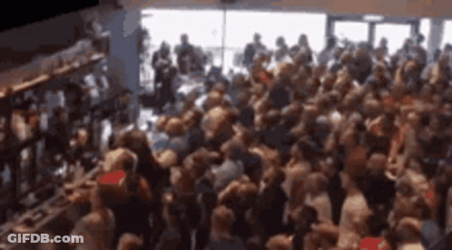 Crowd Gathered In Room By Window GIF