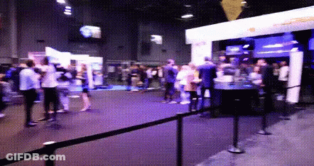 Crowd Gathered In Room With Purple Light GIF