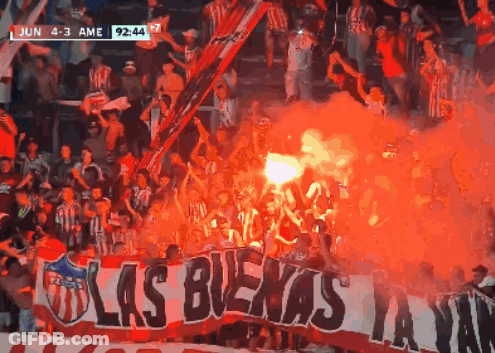 Crowd Holding Banner Saying Las Buena GIF