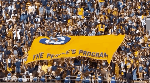 Crowd Holding Yellow Banner Saying The Peoples Program GIF