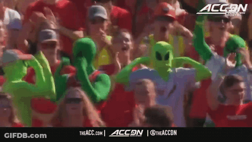 Crowd In Green Alien Costumes With ACCN Logo GIF