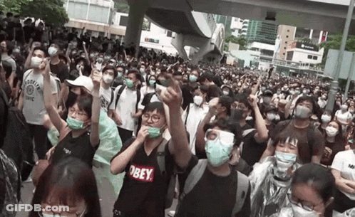 Crowd In Masks And Obey Shirts GIF