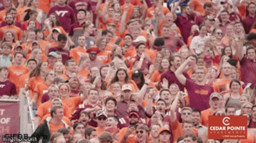 Crowd In Orange Shirts Saying VT GIF