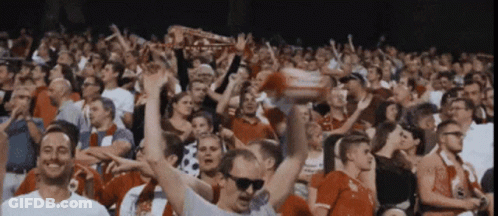 Crowd In Stadium With Man In Sunglasses Holding Liverpool Scarf GIF