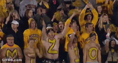 Crowd In Yellow Shirts With M And O On Backs GIF