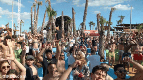 Crowd Of People At Beach Party With Coca-Cola Sign GIF
