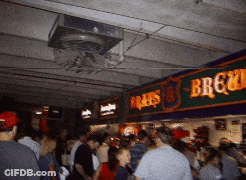 Crowd Of People Under Brau's Brewery Sign GIF