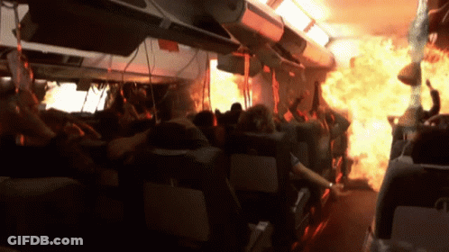 Crowd On Plane With Flames From Ceiling GIF