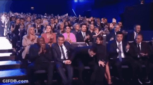 Crowd Sitting In Theater Watching Presentation GIF