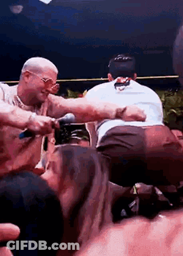 Crowd Surrounding Man With Microphone GIF