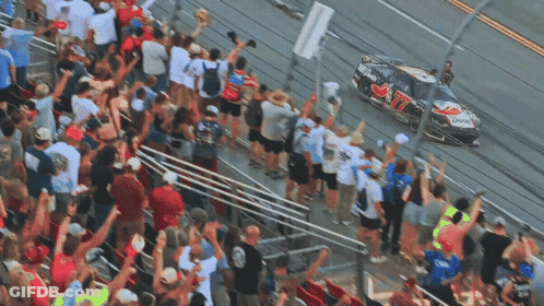Crowd Watching Race Car Number 77 GIF