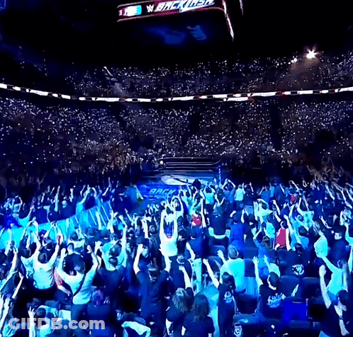 Crowd Watching Wrestler Under Blitzkrieg Sign GIF