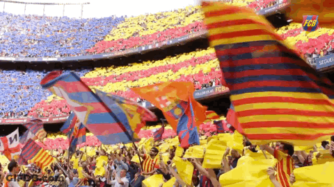 Crowd Waving Flags In Stadium With FC Barcelona Sign GIF