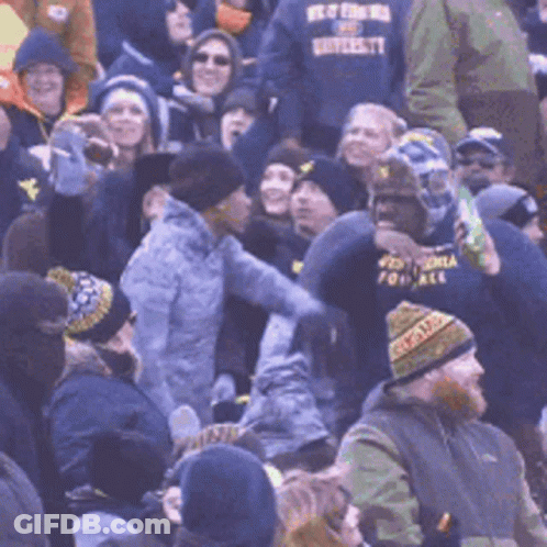 Crowd With Man In Best For Us University Shirt GIF