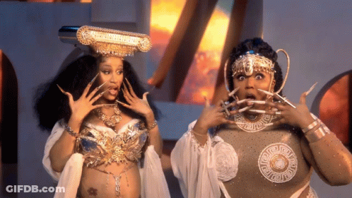 Crowned Woman With Long Nails Next To Woman GIF