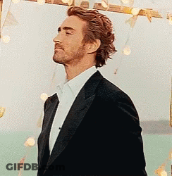 Crying Baby Held By Woman In Crowd GIF